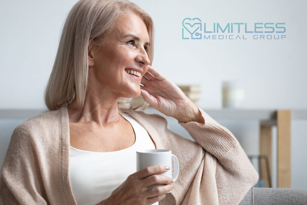 mature woman smiling holding cup.