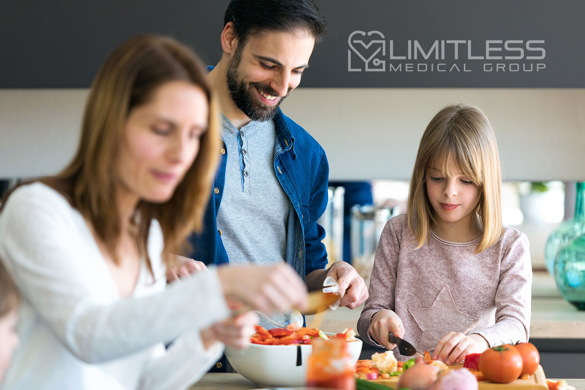 happy family cutting up vegetables.